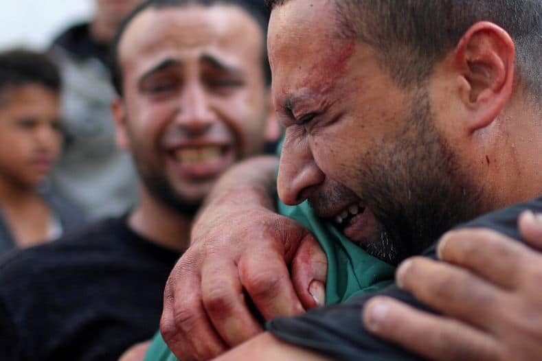 a_palestinian_manx_stained_with_the_blood_of_his_relativex_is_comforted_as_he_reacts_at_shifa_hospital_in_gaza_city_november_13x_2019_1