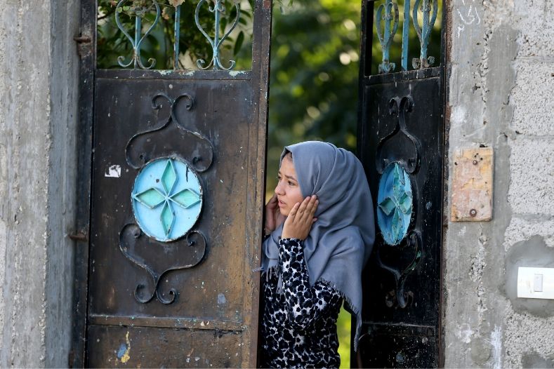 a_palestinian_woman_reacts_as_she_looks_out_of_her_home_in_the_southern_gaza_strip_november_12x_2019_