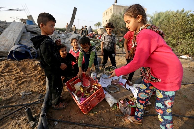 palestinian_children_collect_objects_from_a_house_destroyed_in_an_israeli_air_strike_in_the_southern_gaza_strip_november_13x_2019_