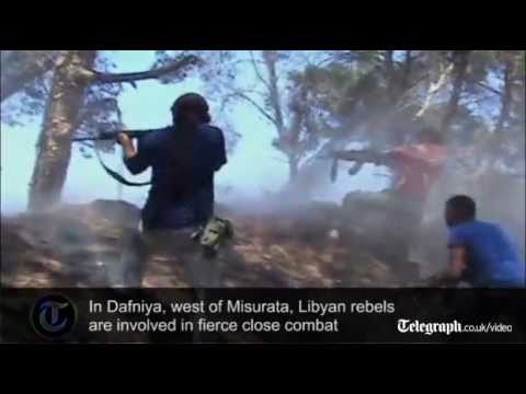 Libyan rebels attck gaddafi  artillery positions as they engage in fierce combat