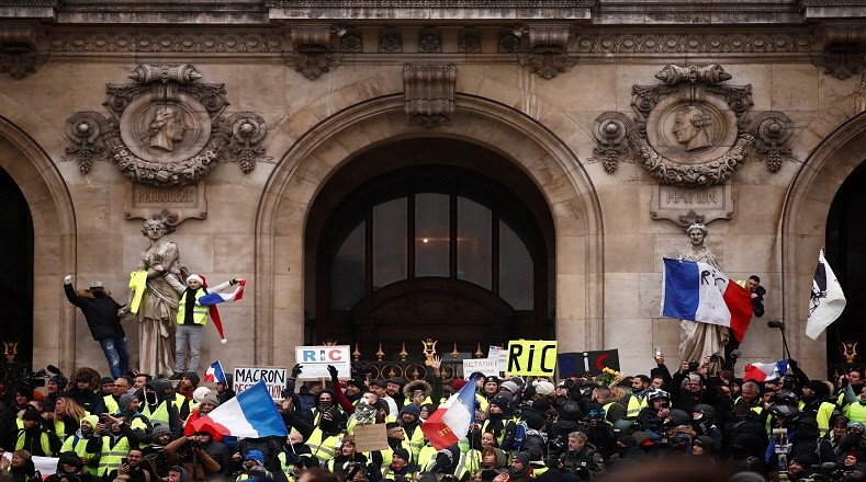 Protesters wearing yellow vests gather in front of the Opera House as part of the "yellow vests" movement in Paris