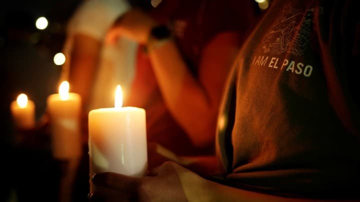 Mourners take part in a vigil at El Paso High School after a mass shooting at a Walmart store in El Paso