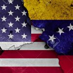 flags of USA and Venezuela painted on cracked wall