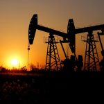 Pumpjacks are seen against the setting sun at the Daqing oil field in Heilongjiang