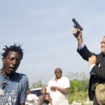 2019-09-23-Sen-Jean-Marie-Ralph-Fethiere-firing-his-weapon-outside-Parliament-by-Andres-Martinez-Casares-of-Reuters-696x392