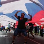 demonstrators_carry_a_giant_chilean_national_flag_during_a_protest_against_neoliberal_economic_model_in_santiagox_chile_oct__25x_2019_.jpg_1718483346