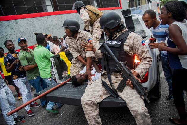 People participate during a demonstration in Port-au-Prince, Haiti, 20 October 2019. At least one person has been kille