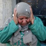 a_palestinian_woman_reacts_as_she_sits_outside_her_home_in_the_southern_gaza_strip_november_12x_2019_