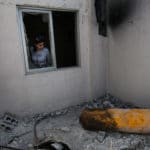 A journalist looks on during a media tour of a damaged house where Organisation for the Prohibition of Chemical Weapons (OPCW) inspectors are belived to have visited in Douma near Damascus
