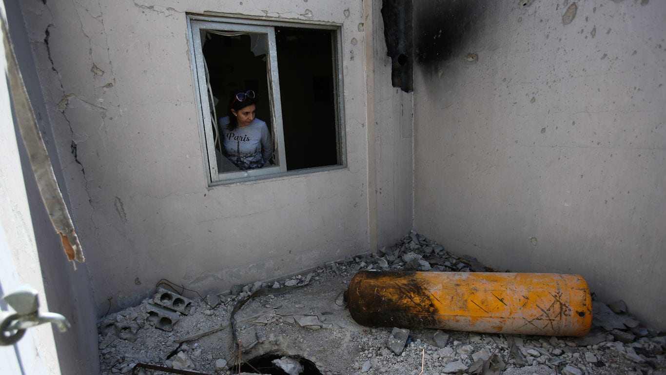 A journalist looks on during a media tour of a damaged house where Organisation for the Prohibition of Chemical Weapons (OPCW) inspectors are belived to have visited in Douma near Damascus