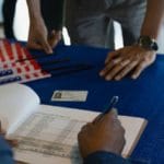 Volunteer checking voters in at polling place