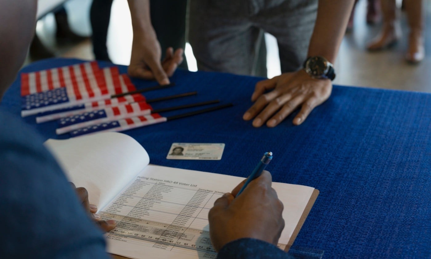 Volunteer checking voters in at polling place