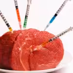Syringes injecting meat, close-up