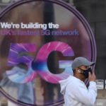 person_passes_in_front_of_a_5g_tech_advertisementx_u_k_x_2020_.jpg_1718483346