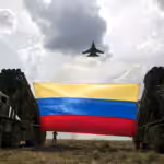 A Russian-made Sukhoi Su-30MKV fighter jet of the Venezuelan Air Force flies over a Venezuelan flag tied to missile launchers, during the "Escudo Soberano 2015" (Sovereign Shield 2015) military exercise in San Carlos del Meta in the state of Apure