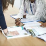 Teacher in classroom helping students study