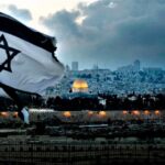 An-Israeli-flag-flutters-at-Mount-of-Olives-with-the-Old-City-of-Jerusalem-and-its-Dome-of-the-Rock-mosque-in-the-centre-March-27-2019.-AFP-1194x640