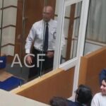 Julian-Assange-court-UK-glass