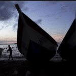 A man walks past wooden boats in the bay of Rio Caribe a town near caribbean islands, in the eastern state of Sucre, Venezuela October 29, 2015. REUTERS/Carlos Garcia Rawlins