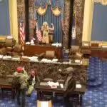 Featured image: File photo. Trump supporters took control of the Congress floor after storming the Capitol with police help. Q-anon