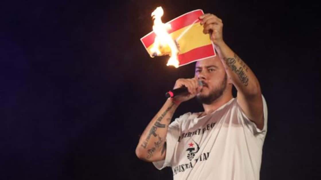 Featured image Pablo Hasél burns a miniature Spanish flag at a concert - Photo Laura Becerra-Última Hora