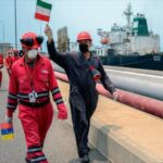 Featured image: A Venezuelan worker waves an Iranian flag celebrating the arrival of the Iranian oil tanker Fortune at a Venezuelan refinery, May 25, 2020 (Photo: AFP).