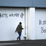 Loyalist graffitis are seen with messages against the Brexit border checks in relation to the Northern Ireland protocol at the harbour in Larne