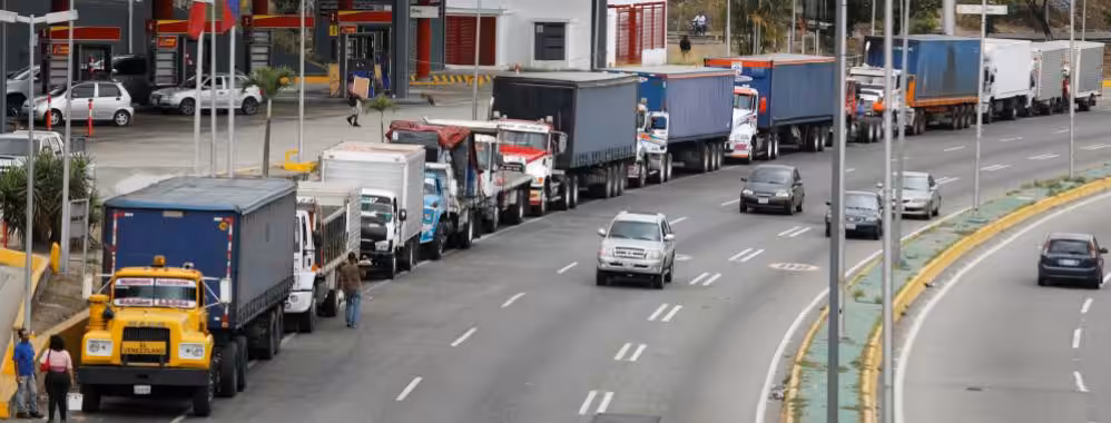 Featured image: Long lines of trucks waiting to load their tanks with fuel and adding to the long lines of cars that are still visible all over Venezuela due to the scarcity created since 2020 as a direct result of US blockade.