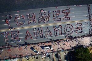 Featured image: Human sign made by 2,500 Venezuelan youths in 2013, a few days after Hugo Chavez passing. File photo.