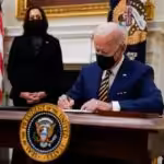 Featured image: President Biden signing executive orders last February at the White House, with Vice President Kamala Harris. Photo: Evan Vucci/Associated Press 