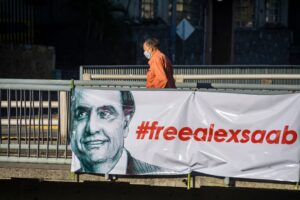 Featured image: Posters in the streets of Caracas demanding the release of Alex Saab. Photo courtesy of Getty Images.