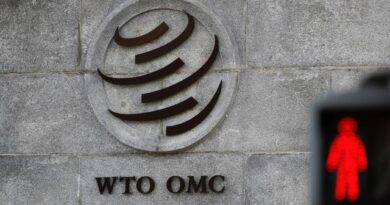 A logo is pictured outside the World Trade Organization (WTO) headquarters next to a red traffic light in Geneva, Switzerland, October 2, 2018. REUTERS/Denis Balibouse