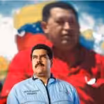 Featured image:  President Nicolas Maduro with a photo of Hugo Chavez in the background. File photo courtesy of RedRadioVE.