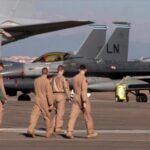 US air forces walk near military aircraft at Incirlik base in Turkey.