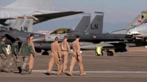 US air forces walk near military aircraft at Incirlik base in Turkey.