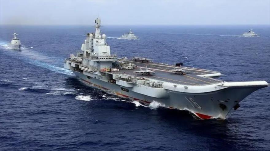 The Chinese aircraft carrier Liaoning with Chinese frigates and guided missile destroyers participating in a military exercise in the Western Pacific, April 2018.