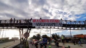 Banner reading "The narco-paramilitary state will fall" hung from a bridge in Bogotá on the morning of April 28. Photo: Congreso de los Pueblos