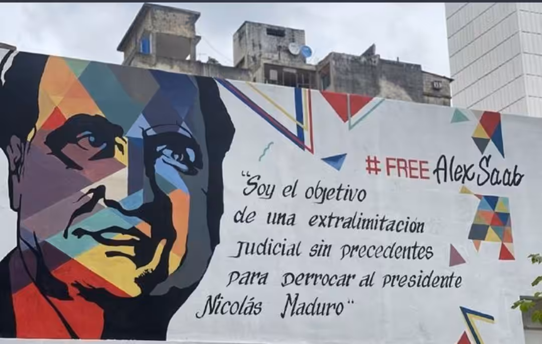 Featured image: Street mural in Caracas with the face of Alex Saab and the caption “I’m the object of an unprecedented legal persecution to oust President Nicolas Maduro.” File photo.