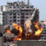 Featured image: An international media building destroy by Israel military in Gaza. Al Jazeera and AP offices operated from this building. The only possible reason behind the bombing is the sudden and recent fair coverage from the Qatari news outlet about the atrocities of Israel against Palestinians. A ball of fire erupts from the Jala Tower as it is destroyed in an Israeli air strike. Picture: Mahmud Hams/AFP