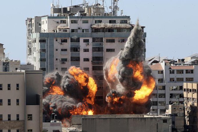 Featured image: An international media building destroy by Israel military in Gaza. Al Jazeera and AP offices operated from this building. The only possible reason behind the bombing is the sudden and recent fair coverage from the Qatari news outlet about the atrocities of Israel against Palestinians. A ball of fire erupts from the Jala Tower as it is destroyed in an Israeli air strike. Picture: Mahmud Hams/AFP