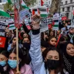Demonstrators hold banners and placards outside Downing Street during a "Save Sheikh Jarrah" demonstration in London on Tuesday, May 11, 2021. At least 24 Palestinians were killed Monday, May 10 in Israeli air raids on Gaza Strip. (Photo: Vudi Xhymshiti/Anadolu Agency via Getty Images)