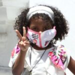 Featured image: Venezuelan kid wearing her face mask. File photo.