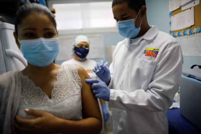 Featured image: Venezuelan woman being vaccinated against COVID-19. File photo.