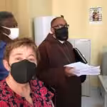 International #FreeAlexSaab Delegation filing Habeas Corpus. From left to right, Pericles Tavares, Sara Flounders and Bishop Felipe Teixeira. Photo by Roger Harris.