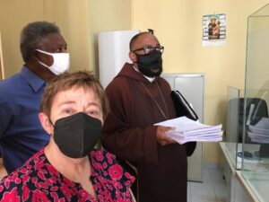 International #FreeAlexSaab Delegation filing Habeas Corpus. From left to right, Pericles Tavares, Sara Flounders and Bishop Felipe Teixeira. Photo by Roger Harris.