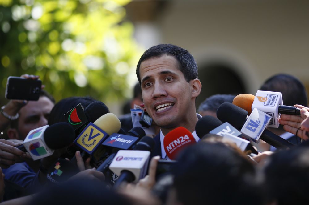 Former deputy Juan Guaido being surrounded by the press. File photo.