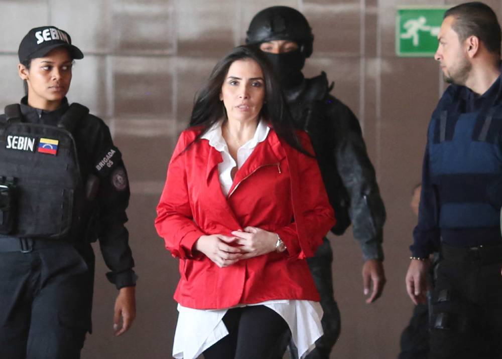 Aida Merlano being escorted by Venezuelan law enforcement officers before being presented and giving testimony to Venezuelan judicial authorities. File photo.