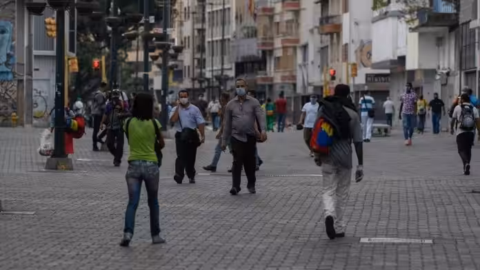 Venezuelans wearing face masks walking in a boulevard at Caracas. File photo.