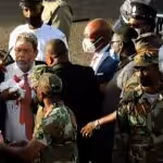 St. Vincent and the Grenadines Prime Minister Ralph Gonsalves, his shirt covered in blood, is evacuated after media reported that he was hit by a stone during a protest in Kingstown, St. Vincent and the Grenadines August 5, 2021. REUTERS/Robertson S. Henry