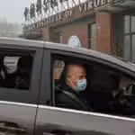 Peter Daszak, right, Thea Fischer, left, and other members of the World Health Organization team investigating the origins of the COVID-19 pandemic arrive at the Wuhan Institute of Virology in Wuhan in China’s central Hubei province on Feb. 3, 2021. (Hector Retamal / AFP / Getty Images).